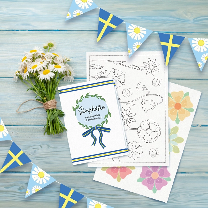 Blandat midsommarpyssel och en bukett blommor på blåa plankor.