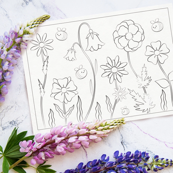 Målarsida föreställande bin och blommor, liggandes på bord med blommor.